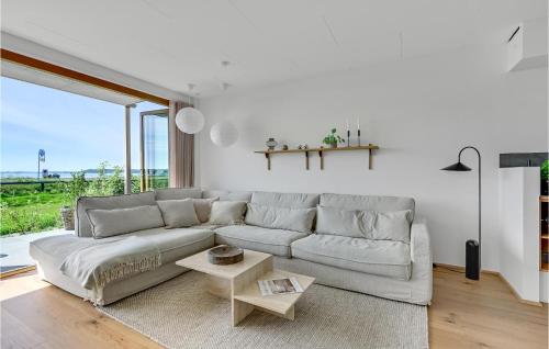 a white living room with a couch and a table at Gorgeous Apartment In Kerteminde in Kerteminde
