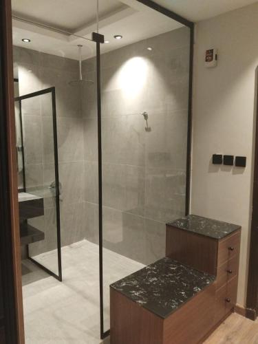 a bathroom with a shower with a glass door at شقق ثري ستار للشقق المخدومة 1 in Riyadh