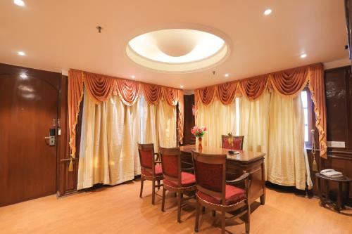 a dining room with a table and chairs at Regenta Orko's Haridwar, Motichur, 10 min from Har ki Pauri in Haridwār