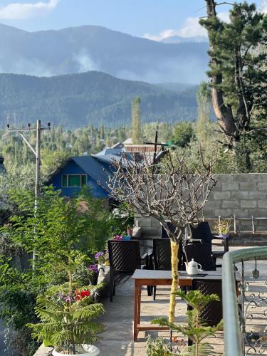 a patio with a table and chairs and plants at Everest Guest House in Gulmarg