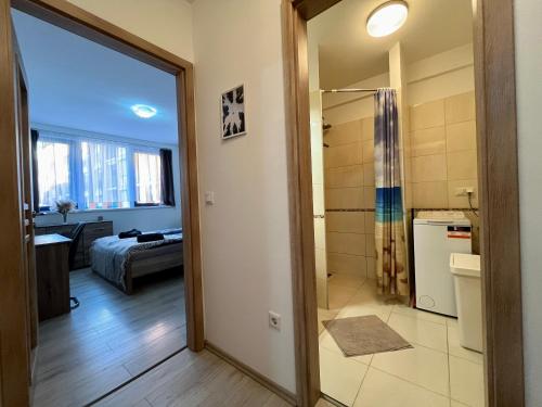 ein Badezimmer mit Dusche und ein Schlafzimmer in der Unterkunft City Centre Simonffy Apartment in Debrecen