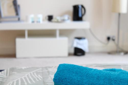 a blue pillow sitting on top of a bed at Darwin road guest house 3 in Southampton