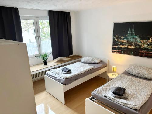 Llit o llits en una habitació de WelcomeCologne Apartments