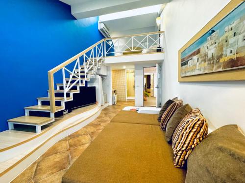 a living room with a couch and a staircase at 真情非凡行館 Sealuv Homestay in Toucheng