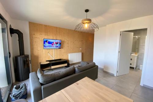 a living room with a couch and a tv at 06CI Beautiful T2 apartment with terrace - Valberg in Valberg