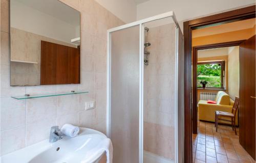 a bathroom with a white sink and a shower at Valguerriera - Sorgo in Apecchio