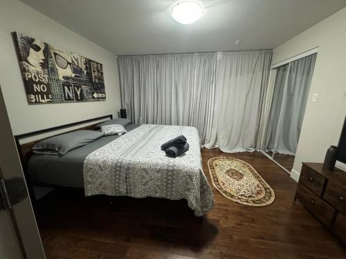 a bedroom with a bed with a hat on it at Amazing 3-Bedrooms in Rosemont - Montreal in Montréal