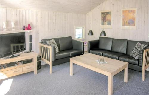 a living room with two couches and a tv at Holiday Home Humble 34 With Hot Tub in Humble