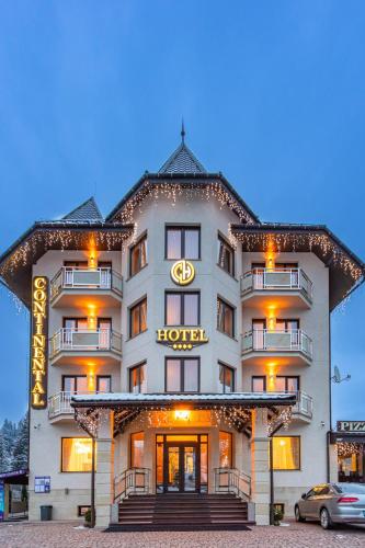 a hotel with a sign on the front of it at Continental SPA Resort in Bukovel
