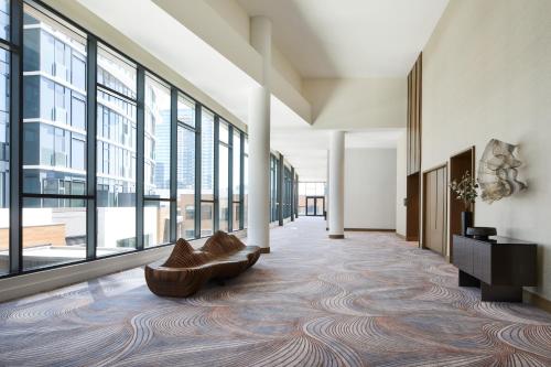 a lobby with a couch and large windows at InterContinental Seattle Bellevue, by IHG in Bellevue