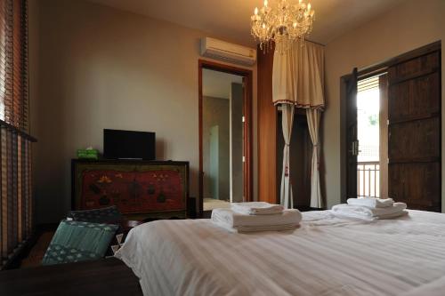 a bedroom with a large bed with towels on it at Villa Bangkok in Bangkok