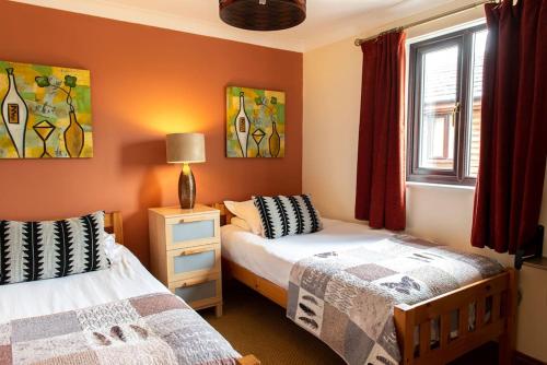 a bedroom with two beds and a window at Harvest 1 Lodge, Yellowtop Country Park in Selby