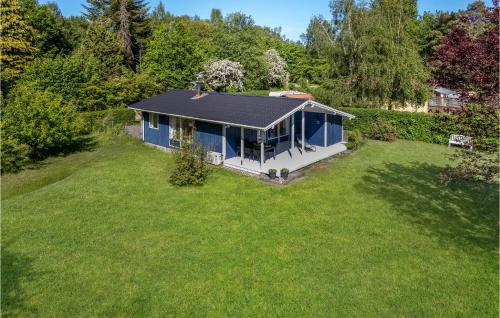 an overhead view of a blue house in a yard at Awesome Home In Grevinge With Wifi in Grevinge