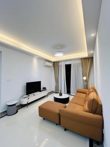 a living room with a couch and a tv at R&F Princess Cove View Residences by WSD in Johor Bahru