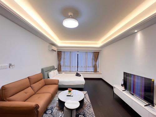 a living room with a couch and a tv at R&F Princess Cove View Residences by WSD in Johor Bahru
