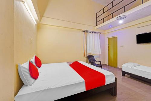 a hotel room with a bed and a tv at Hotel O Le Serenity Beach View Resort in Kottakupam