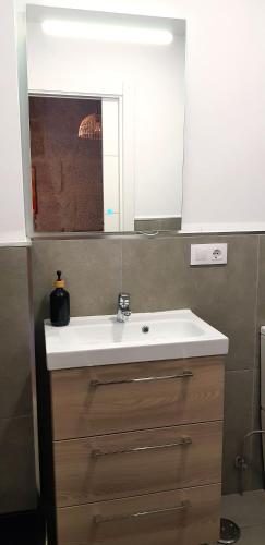a bathroom with a white sink and a mirror at Apartamentos Principe in Vigo