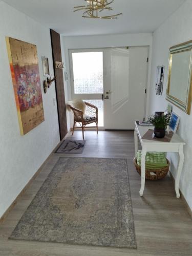 a living room with a table and a chair at Ferienwohnung Haseltal in Bad Orb