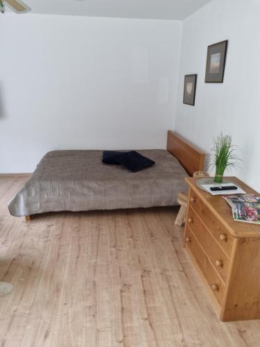 a bedroom with a bed and a wooden desk at Ferienwohnung Haseltal in Bad Orb