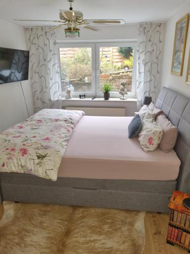 a bedroom with a bed and a window at Ferienwohnung Haseltal in Bad Orb