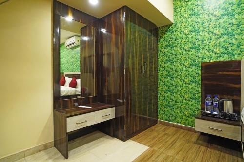 a bathroom with a shower and a large mirror at Gharana Resort , Singur !! Best Family Resort Near Kolkata with Swimming pool !! in Singur
