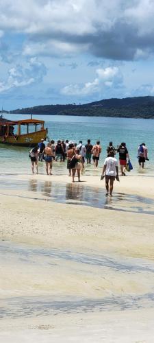 a group of people walking on the beach at Top View Kohrong in Koh Rong