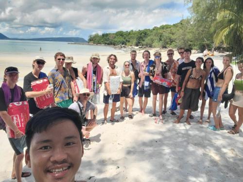 a group of people posing for a picture on the beach at Top View Kohrong in Koh Rong