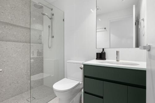 a bathroom with a toilet and a sink and a shower at Bokarina Beach Apartments, an Ascend Collection Hotel in Bokarina