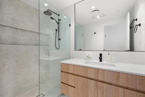 a bathroom with a sink and a shower at Bokarina Beach Apartments, an Ascend Collection Hotel in Bokarina