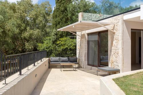 a patio with a couch and a table at Evylio Stone Houses in Lithakia