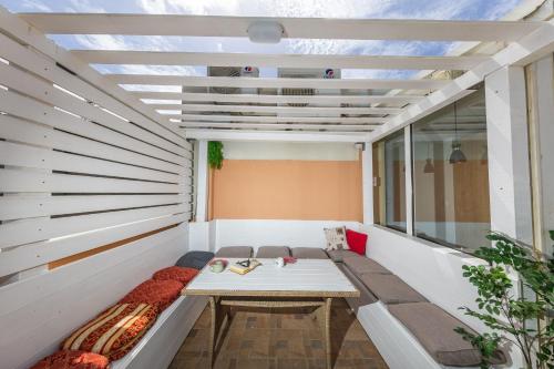 a room with a bench on a balcony at Hostel Petra Marina in Dubrovnik
