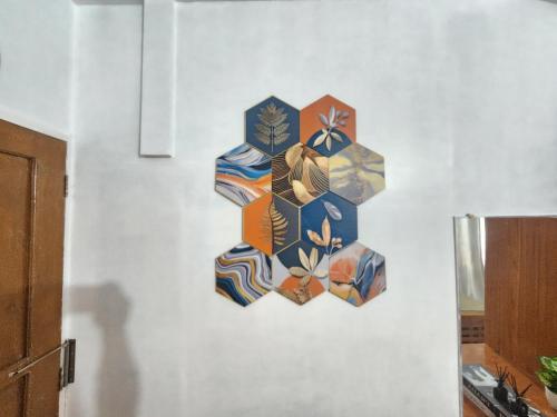 a wall with a painting of umbrellas on it at Casa Del Chen - Budget Friendly Stay - 20-30 Pax in Aringay