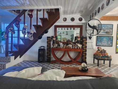 a bedroom with a staircase and a table in a room at Casa Del Chen - Budget Friendly Stay - 20-30 Pax in Aringay
