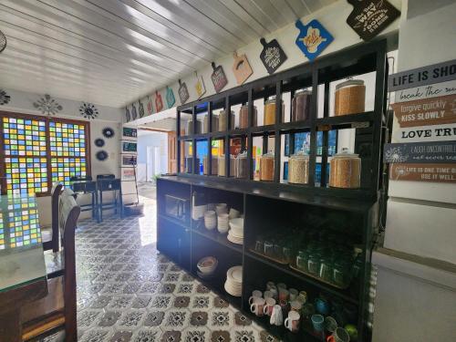 a store with a shelf filled with lots of bottles at Casa Del Chen - Budget Friendly Stay - 20-30 Pax in Aringay