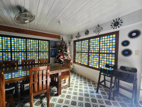 a dining room with a table and stained glass windows at Casa Del Chen - Budget Friendly Stay - 20-30 Pax in Aringay
