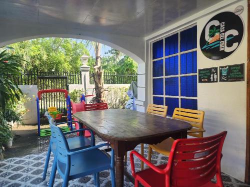 a group of chairs around a wooden table at Casa Del Chen - Budget Friendly Stay - 20-30 Pax in Aringay