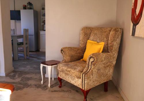 a yellow pillow on a brown chair in a room at Fossil Hills in McGregor
