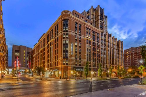 a large brick building on a city street at night at Cambria Hotel Rockville in Rockville