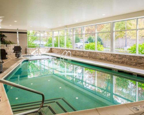 a swimming pool in a house with a large window at Cambria Hotel Traverse City in Traverse City