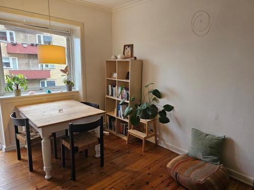 a dining room with a table and a book shelf at City oasis in Copenhagen