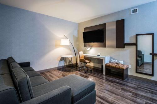 a living room with a couch and a desk at Cambria Hotel McAllen Convention Center in McAllen
