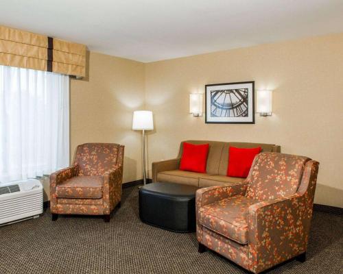 a hotel room with a couch and two chairs at Cambria Hotel Appleton in Appleton