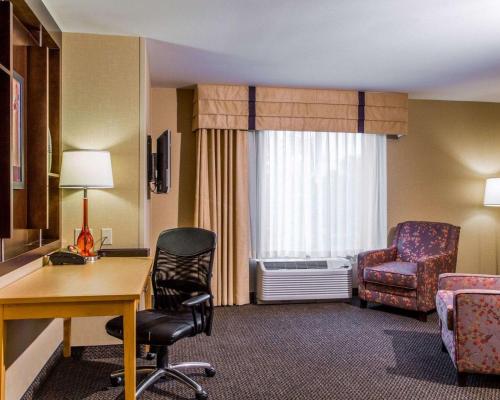 a hotel room with a desk and a chair and a window at Cambria Hotel Appleton in Appleton