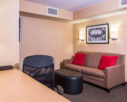 a living room with a couch and a table at Cambria Hotel Appleton in Appleton