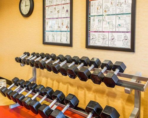 a row of chairs in a gym with a clock on the wall at Cambria Hotel Appleton in Appleton
