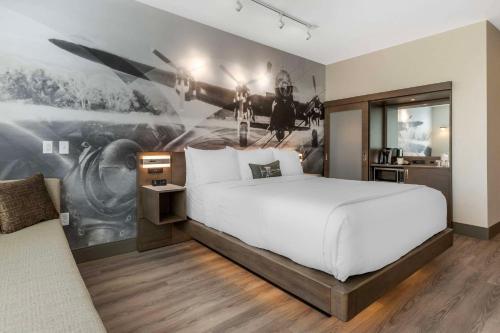 a bedroom with a large bed with a painting on the wall at Cambria Hotel - Arundel Mills BWI Airport in Hanover