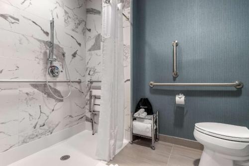 a bathroom with a toilet and a shower at Cambria Hotel West Orange in West Orange