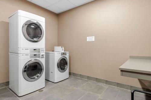 a laundry room with two washer and dryer at Cambria Hotel Mount Pleasant - Charleston in Charleston