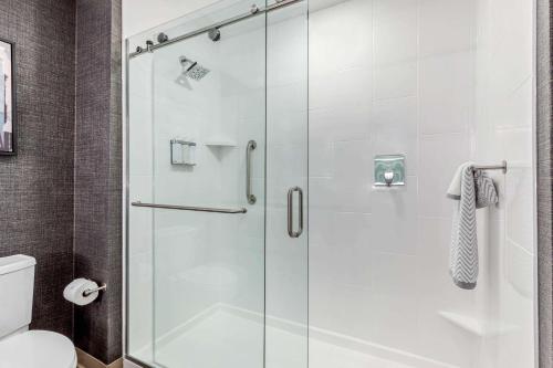 a shower with a glass door in a bathroom at Cambria Hotel Milwaukee Downtown in Milwaukee