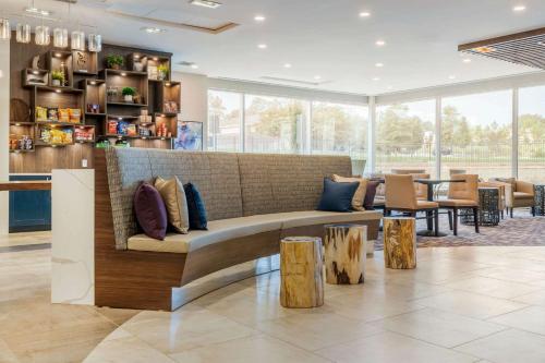a living room with a couch and some tables at Cambria Hotel Fort Mill in Fort Mill
